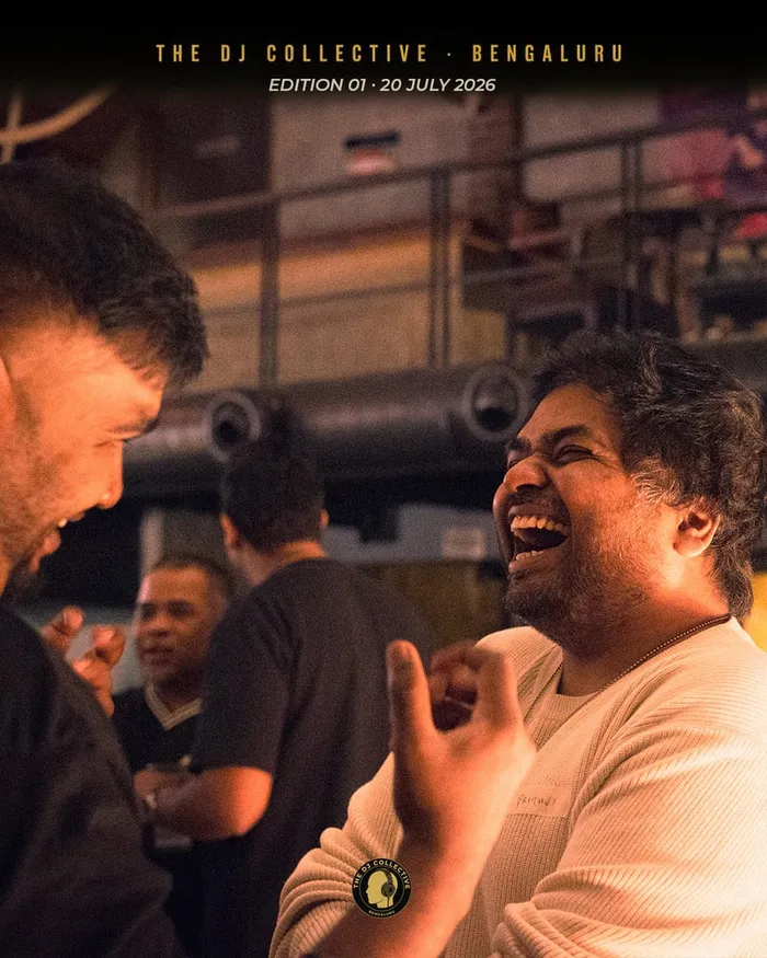 A DJ laughing hard mid-conversation